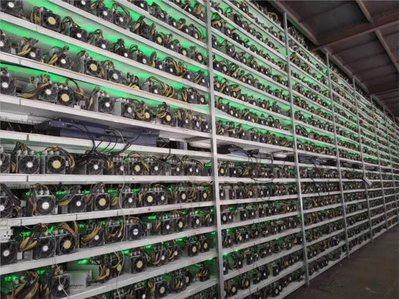 Expansive cryptocurrency mining farm illuminated with rows of powerful mining rigs